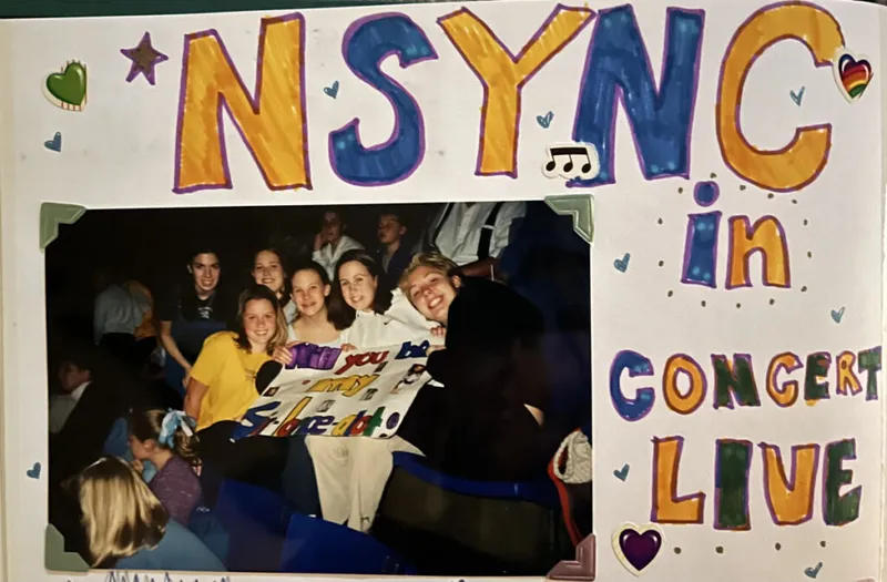 Scrapbook page reading '*NSYNC in Concert Live' with photo of smiling teens holding a fan sign