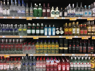 Liquor store shelves stocked with rows of spirits and bottled alcohol