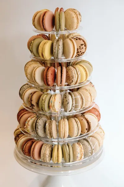 Seven-tier acrylic stand filled with assorted pastel-colored macarons
