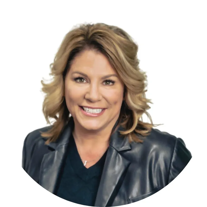 Smiling woman with wavy blonde hair wearing a dark leather blazer
