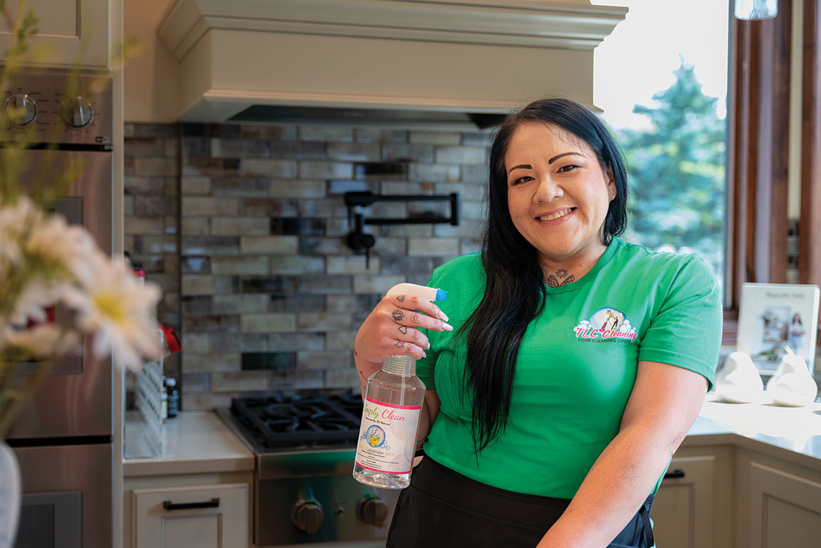 Veronica McCloud holding a TLC Cleaning product