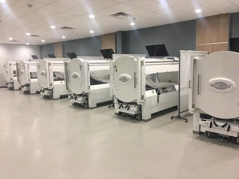 Row of white Sechrist hyperbaric chambers in a clinical facility