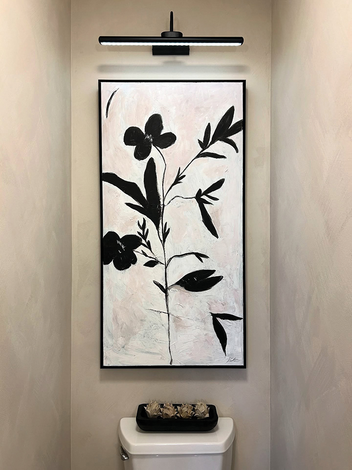 Renovated powder room with floral artwork