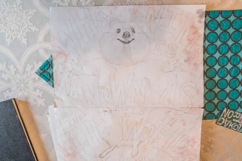 Pencil sketch of a fluffy dog surrounded by hand-lettered text on wrinkled paper