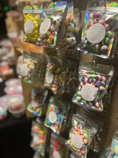 Holographic pouches of colorful freeze-dried candy displayed on a retail rack