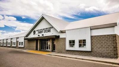 Exterior of a Boys and Girls Ranch Thrift Store in a large gray brick building