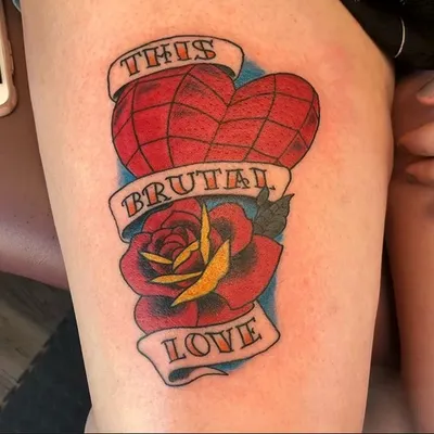 Traditional-style tattoo of a red heart and rose with banner reading 'This Brutal Love