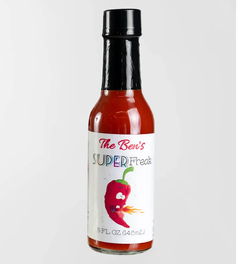 Small bottle of The Ben's Super Freak hot sauce with a fire-breathing chili pepper cartoon label, 5 fl oz
