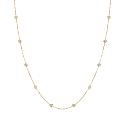 Delicate gold chain necklace with evenly spaced round bezel-set clear stones
