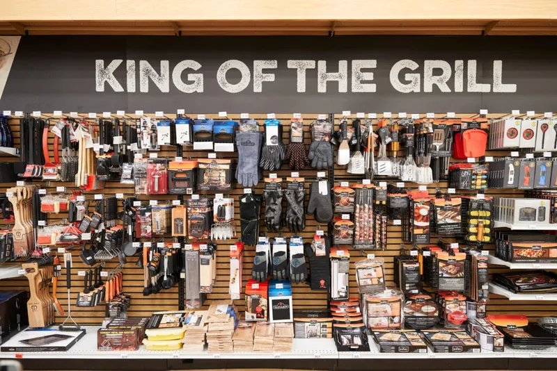 Retail display wall of grilling tools and accessories under a "King of the Grill" sign