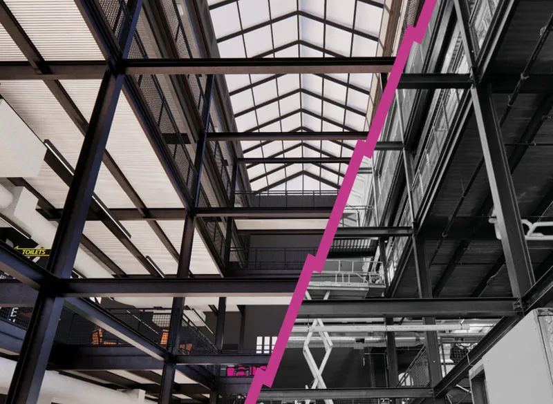 Interior steel framework and skylight roof of a large industrial venue with a bold pink diagonal line overlay