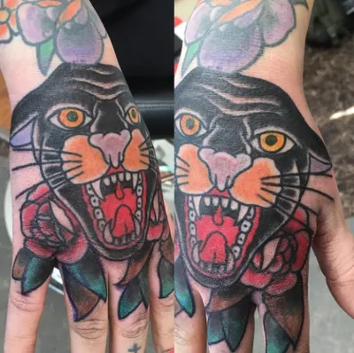 Two hands displaying matching black panther and rose tattoos in traditional style