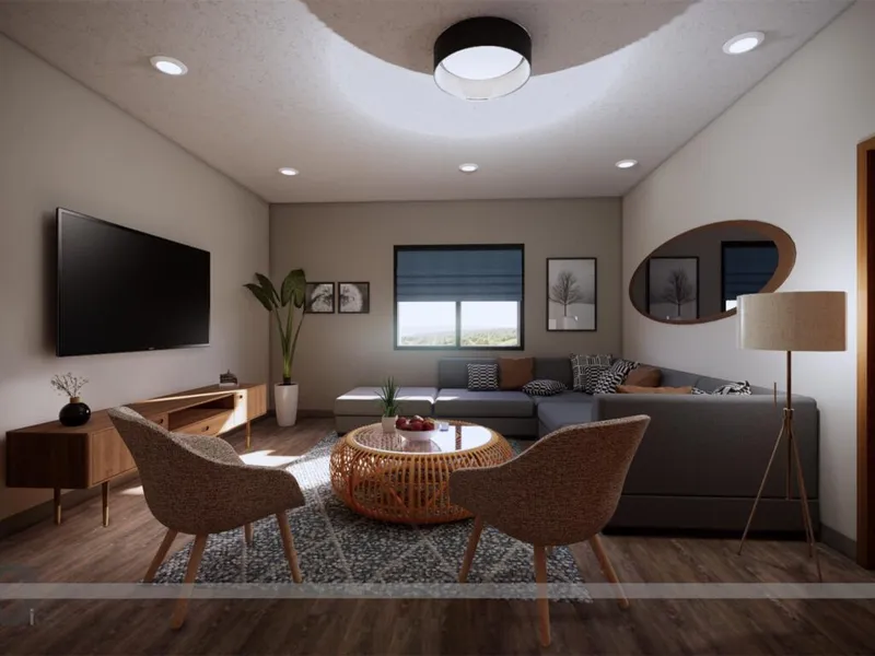 Modern living room with gray sectional, rattan coffee table, two woven chairs, and wall-mounted TV