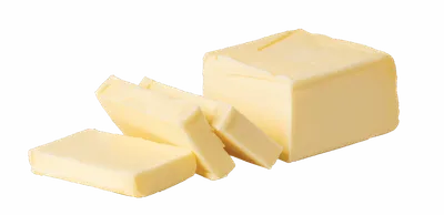 Block of butter with two sliced pats on a white background