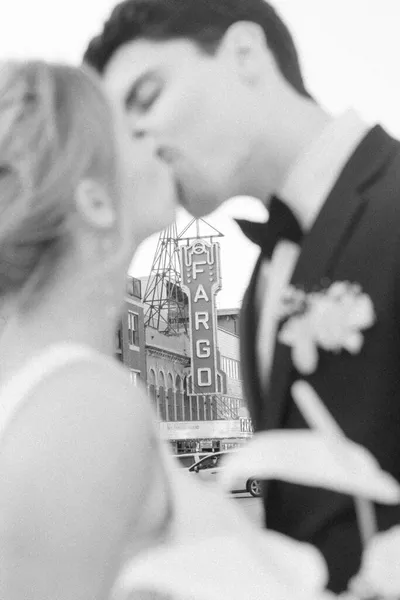 Couple kissing in front of the Fargo Theatre marquee, black and white