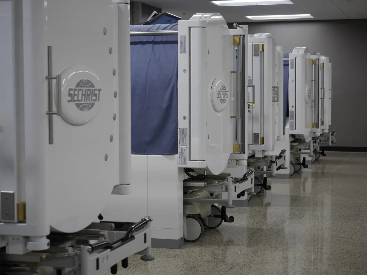 Row of Sechrist hyperbaric chambers lined up in a clinical facility