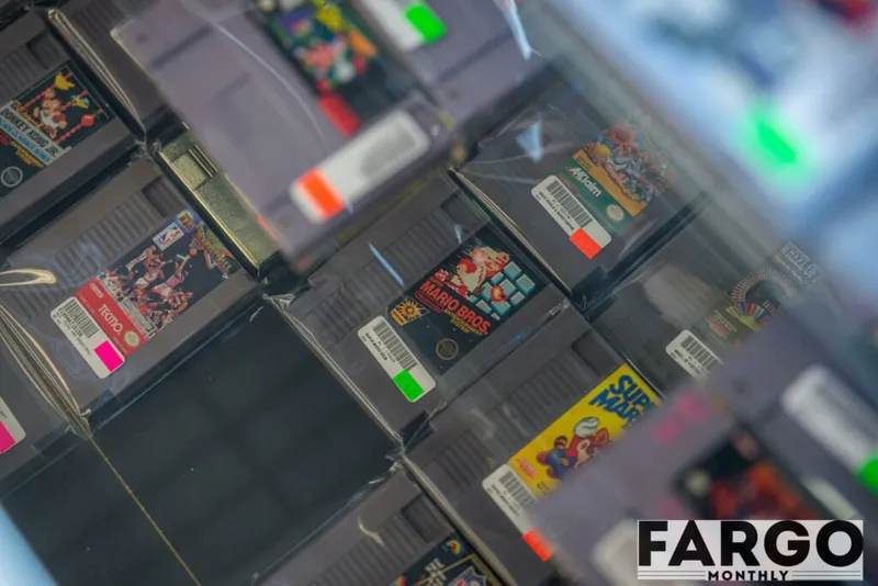 Rows of vintage NES cartridges including Mario Bros and Super Mario on display