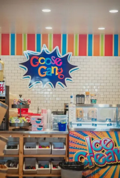 Goose Gang ice cream shop interior with colorful striped wall and toppings bar