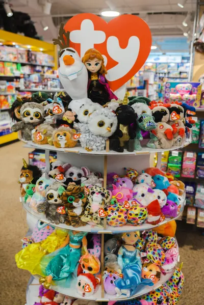 Tiered retail display of colorful Ty Beanie Boo plush toys topped with a red Ty heart logo