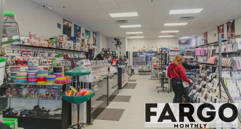 Woman browsing shelves in a video game and hobby retail store