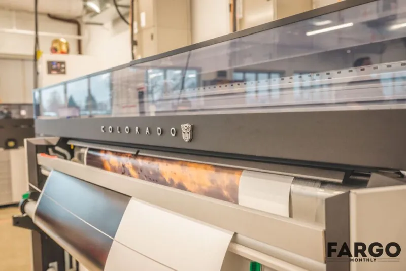 Close-up of a Colorado wide-format printer outputting a colorful large-scale print