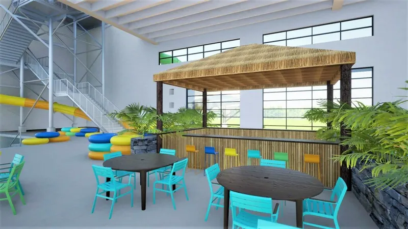 Indoor waterpark rendering with tiki bar, turquoise chairs, and colorful inner tubes near a yellow slide