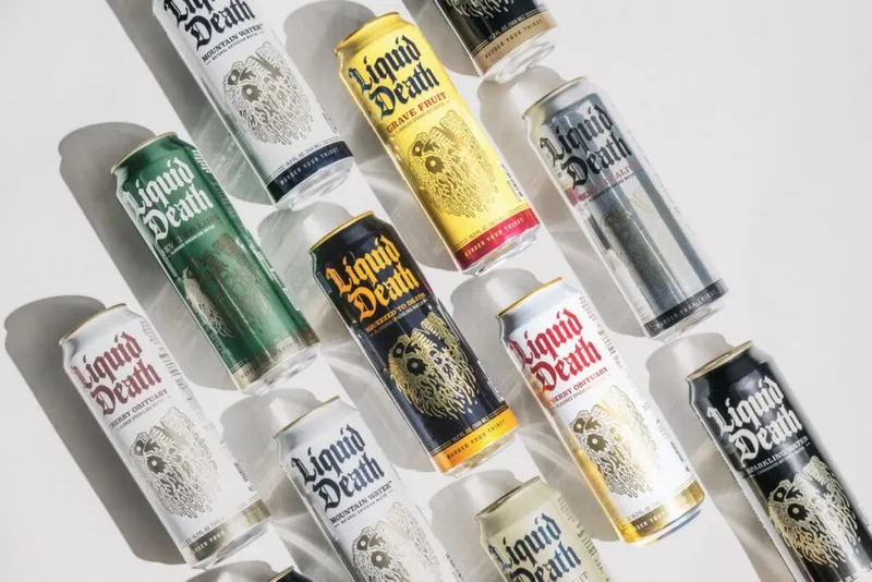 Assorted Liquid Death canned water varieties arranged on a white surface