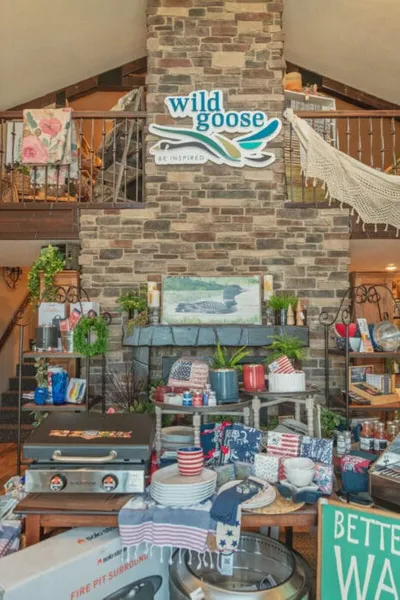 Wild Goose store interior with stone fireplace, patriotic decor, and loft above
