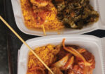 Two takeout containers of Asian dishes with chopsticks