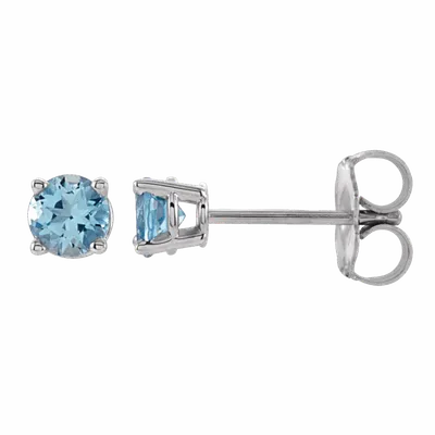 Pair of round light blue gemstone stud earrings with silver prong settings and push backs