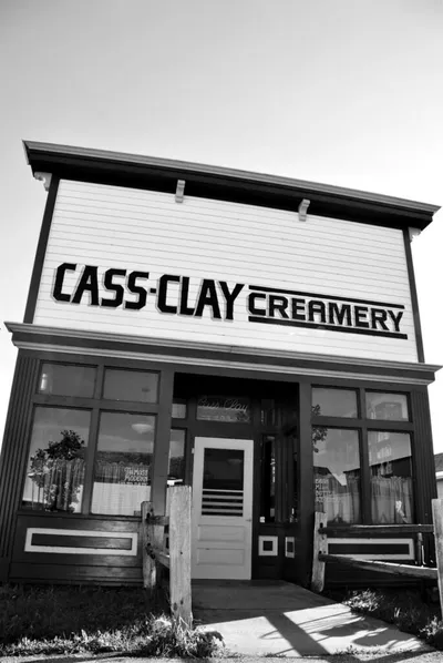 Black-and-white exterior of the Cass-Clay Creamery building with bold signage