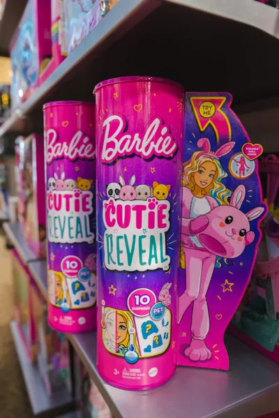Barbie Cutie Reveal toy cylinders displayed on a store shelf