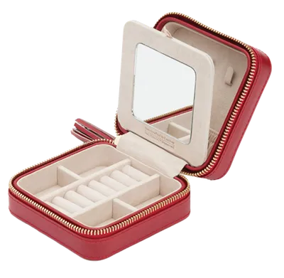 Open red zip travel jewelry case with mirror lid and cream interior compartments