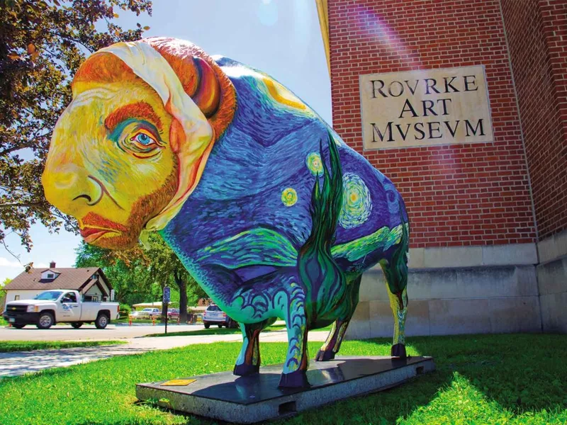 Painted bison sculpture with Starry Night design outside Rovrke Art Museum