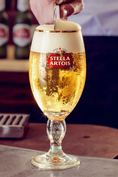 Chilled Stella Artois lager in a branded chalice glass with foamy head