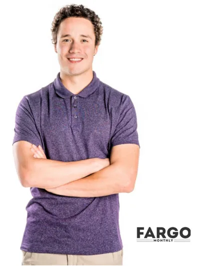 Smiling young man with arms crossed wearing a purple polo shirt