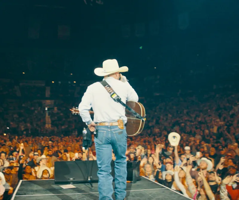 Cody Johnson performing in front of a live stage