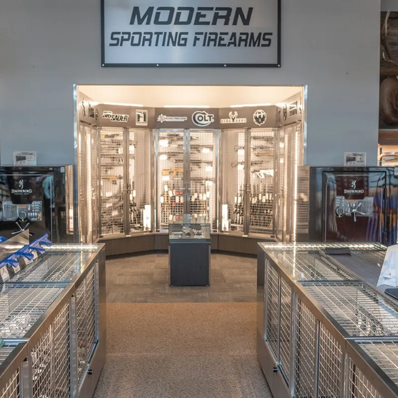 Modern Sporting Firearms display section with lit glass cases and brand signage