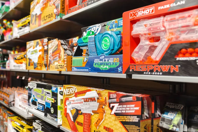 Store shelves stocked with Nerf and X-Shot foam blaster toy boxes