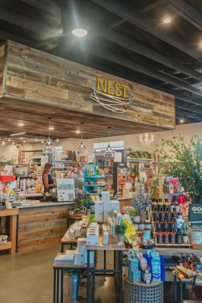 Interior of Nest shop with rustic wood signage, gift displays, and staff behind the counter