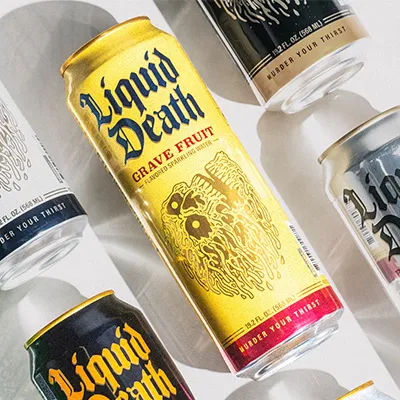 Several Liquid Death tall cans fanned out, yellow Grave Fruit flavor prominently centered