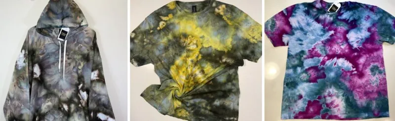 Three ice-dyed garments: a grey hoodie, a yellow-green tee, and a purple-blue tee